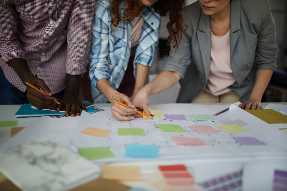 Team mapping an implementation roadmap with sticky notes